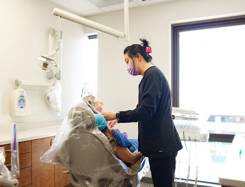 Happy Patient getting dental checkup and cleaning in Fullerton