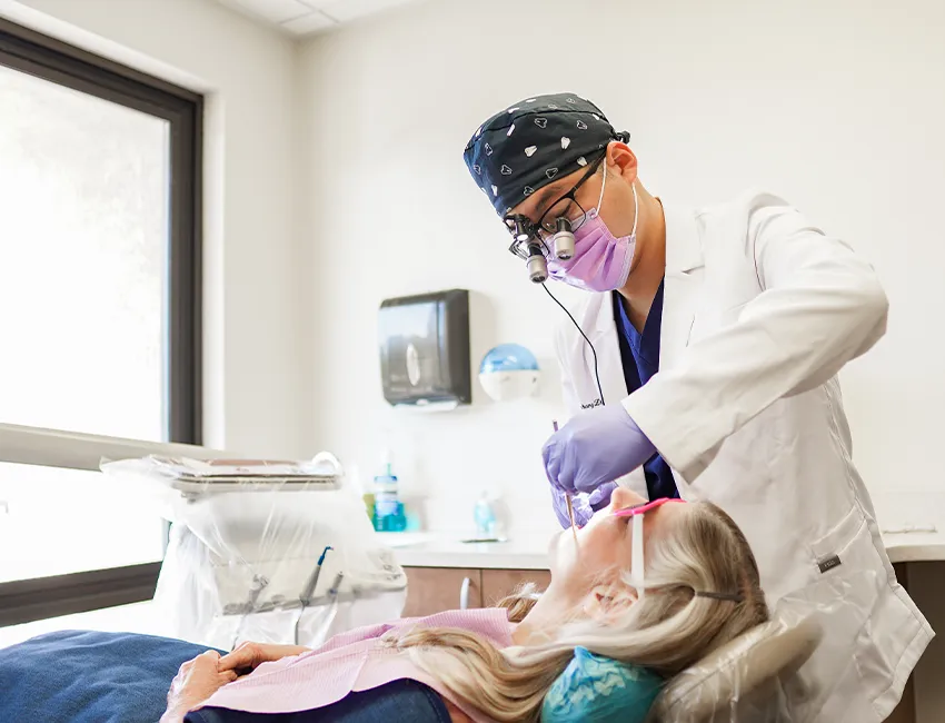 Dentist checking patients dental crown