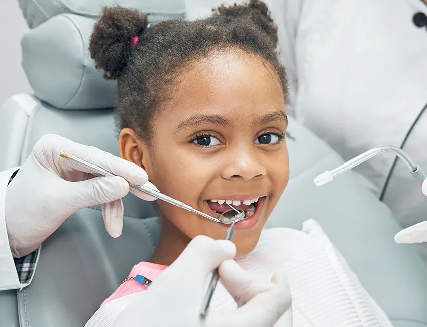 Patient smiling at her nearby dentistry