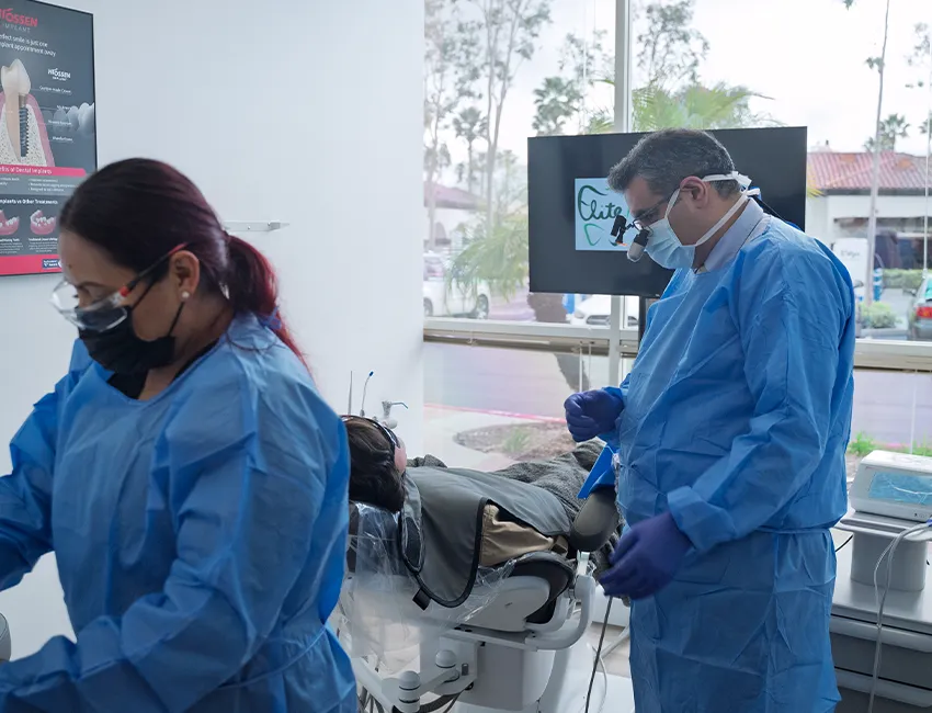 Female patient setting on dental chair with tooth pain at Elite Dentistry