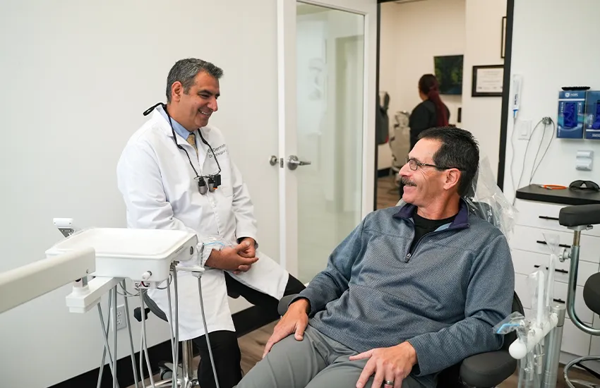 Dentist and patient smiling