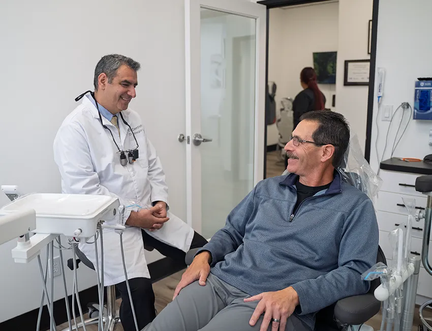 Patient and dentist smiling