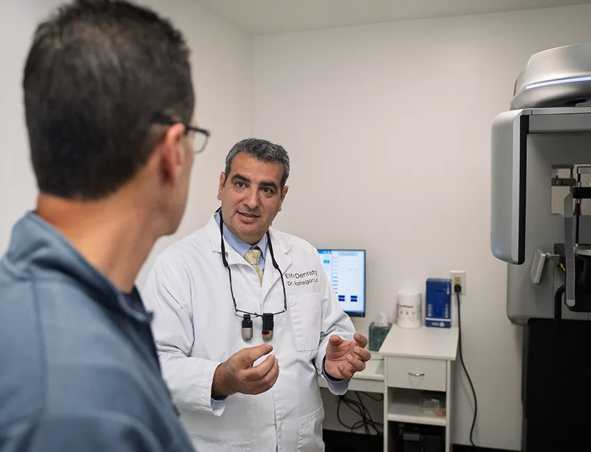 Dr. Lari and patient next to dental X-ray