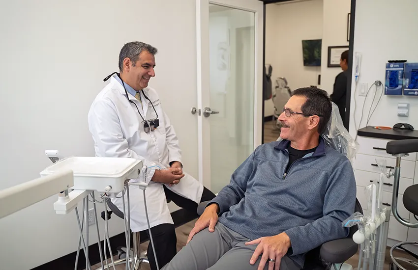 Dentist and patient smiling