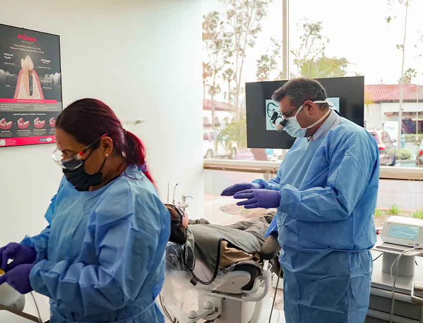 Female patient setting on dental chair with tooth pain at Elite Dentistry