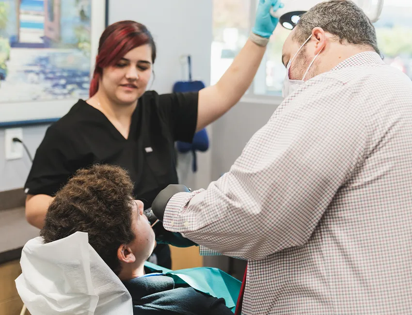 Dentist checking patients teeth