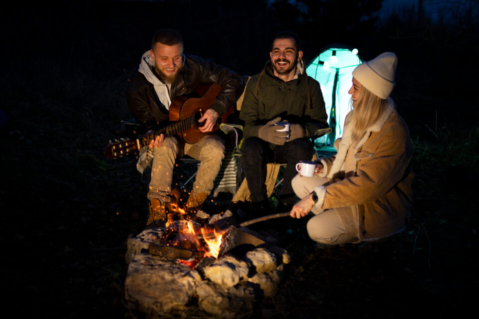 Singing Christmas songs around a campfire