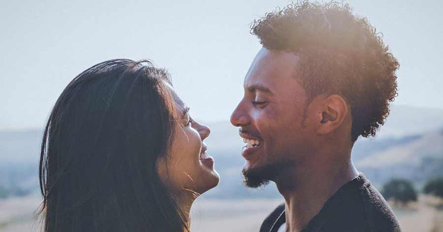 A photo of a couple looking happily at each other.