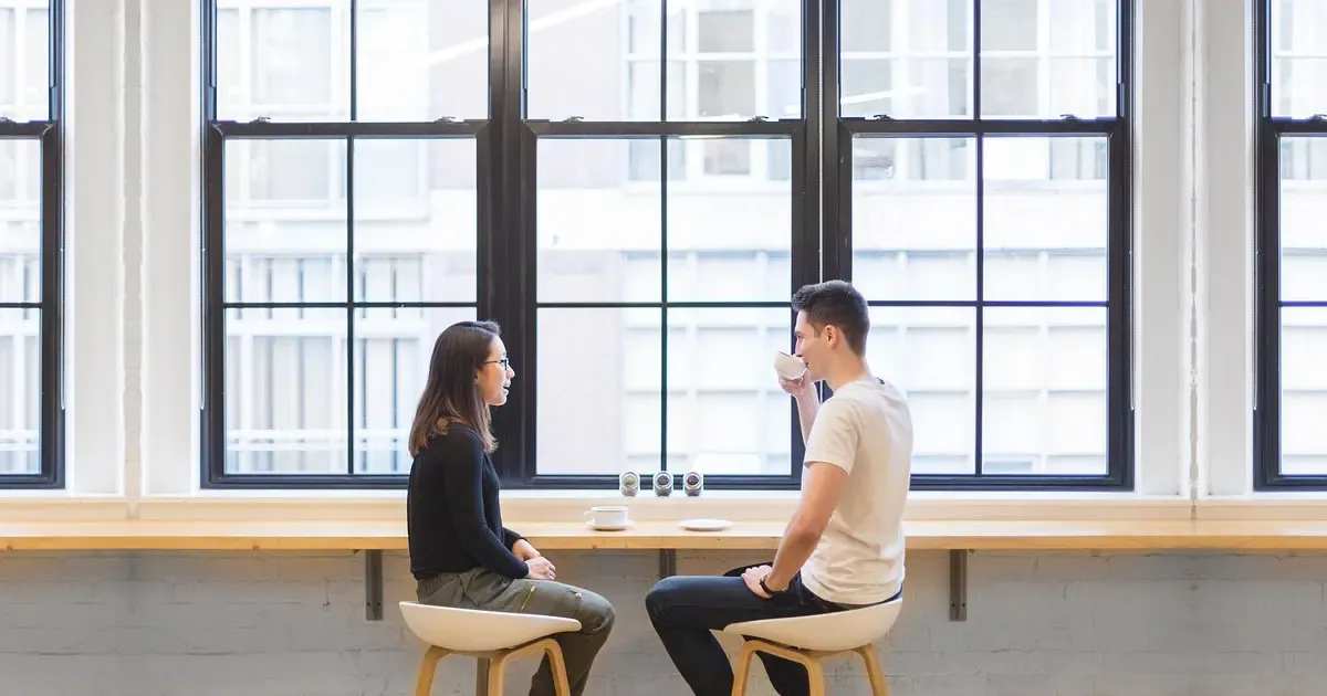 first-date.webp A photo of a man and a woman in a cozy coffee shop