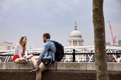 A photo of a woman and man talking while sitting outside