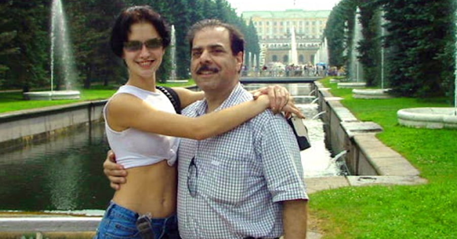 A foreign woman and man posing for a picture