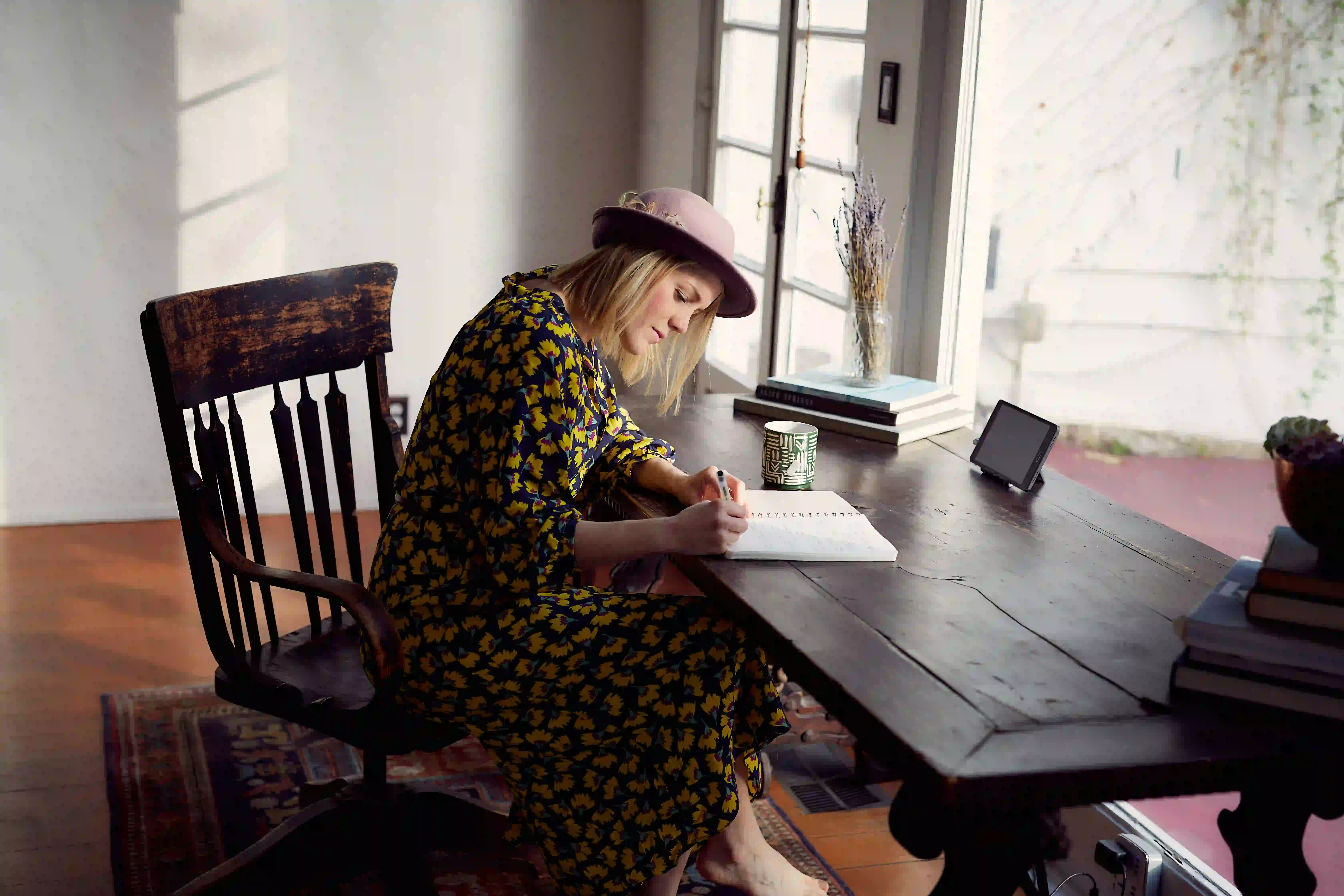 how-to-get-over-heartbreak.webp Woman trying to get over heartbreak by journaling her feelings