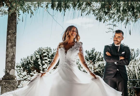 perfectmatch.avif A woman wearing a white wedding dress dancing in front of her groom.