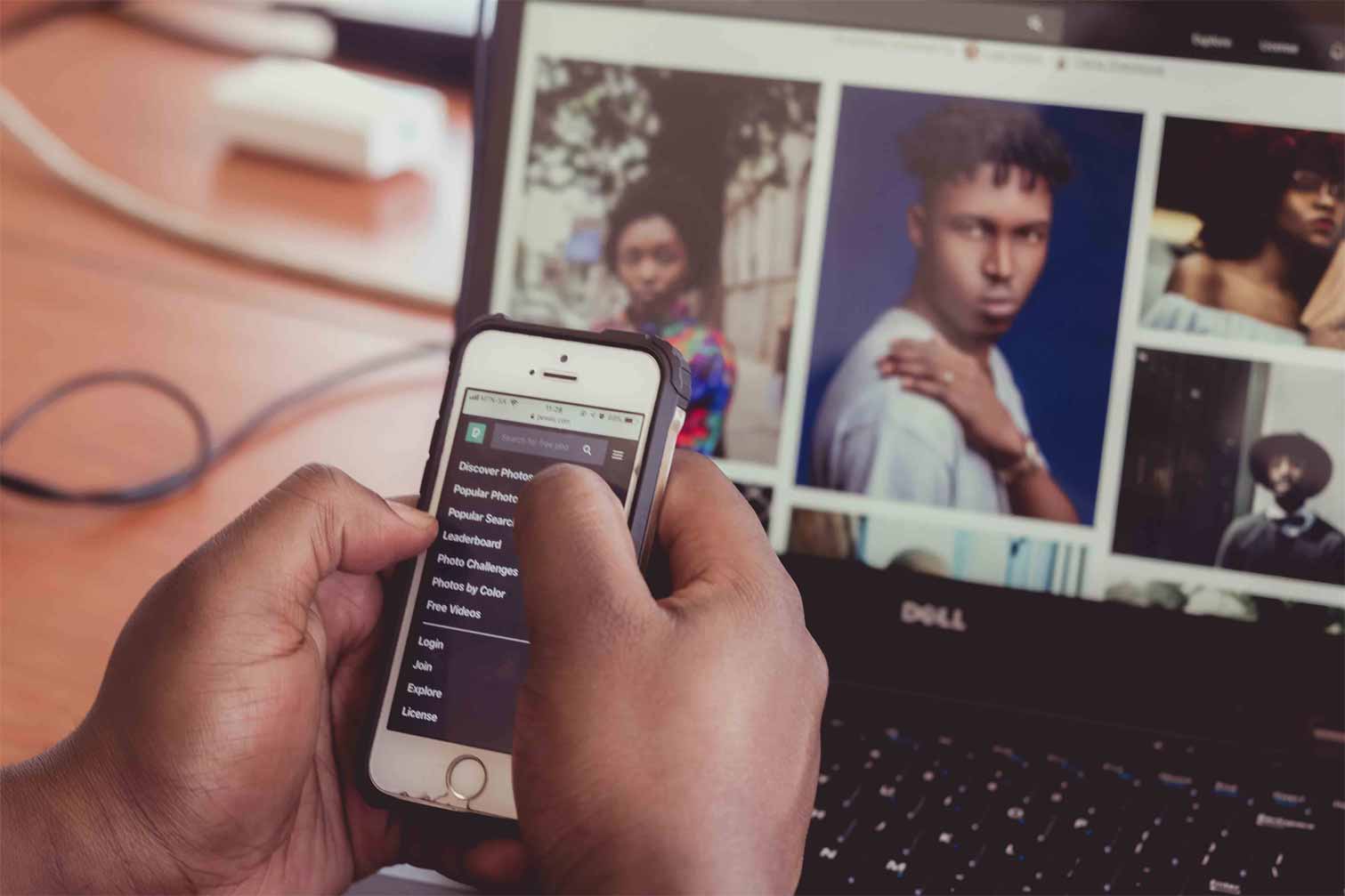 person using phone and laptop