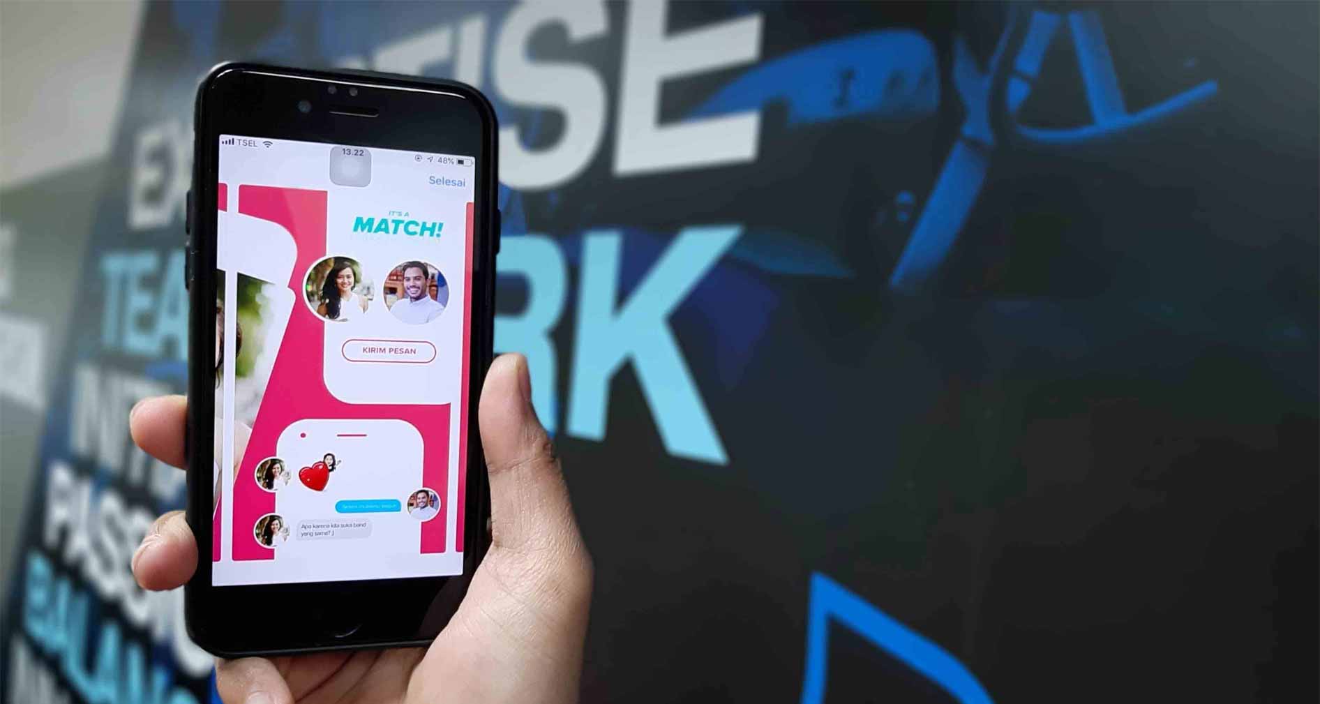 hands on laptop with phone on a couch