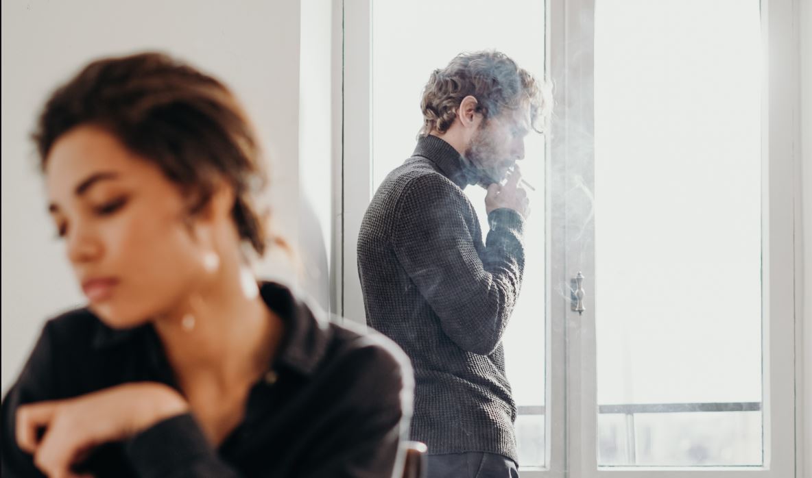 A photo of a couple who seem to be giving each other the silent treatment