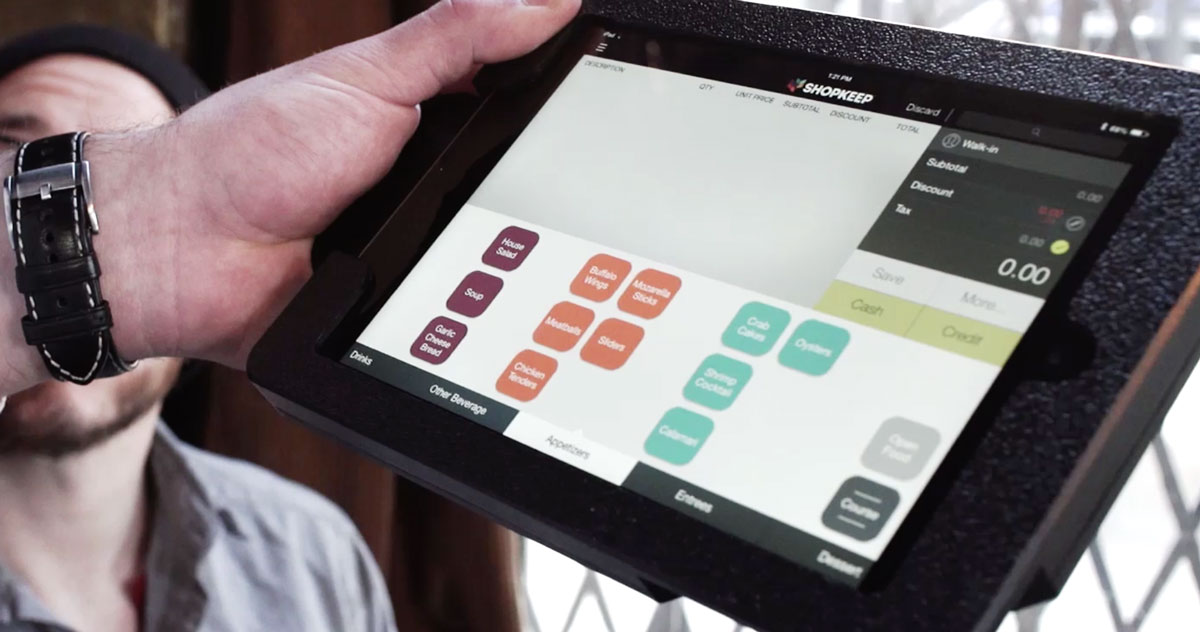 small business owner using a ShopKeep POS terminal