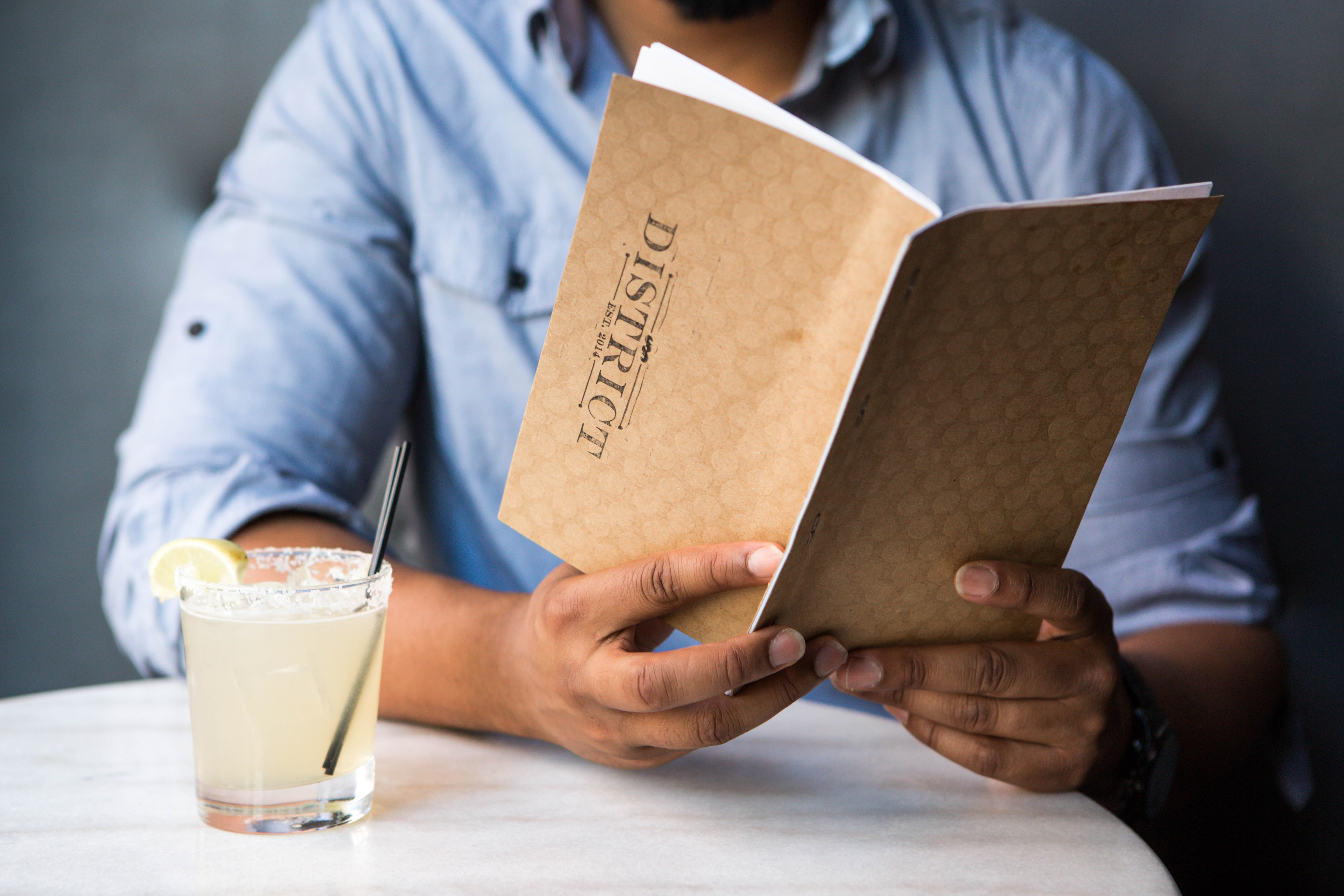 man holding a bar menu