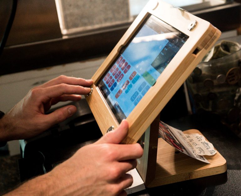 person using a ShopKeep POS terminal