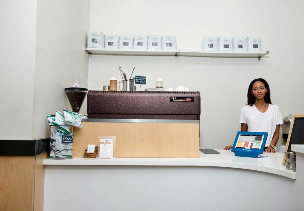 Coffee shop employee behind a counter.