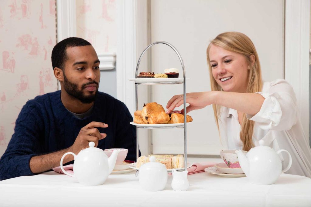 Couple eating pastries at a table