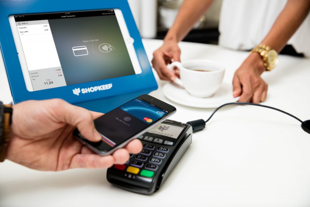 Customer using ShopKeep and Apple Pay to purchase a cup of coffee.