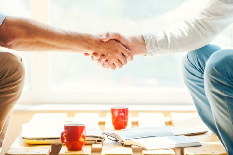 Two people shaking hands.