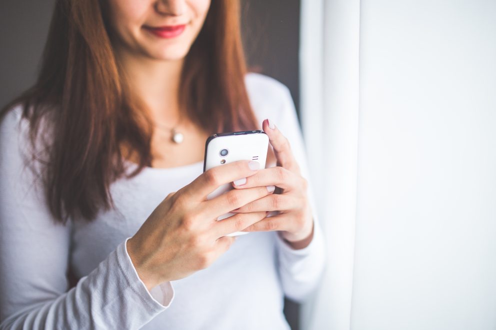 Woman checking her social media on her phone.