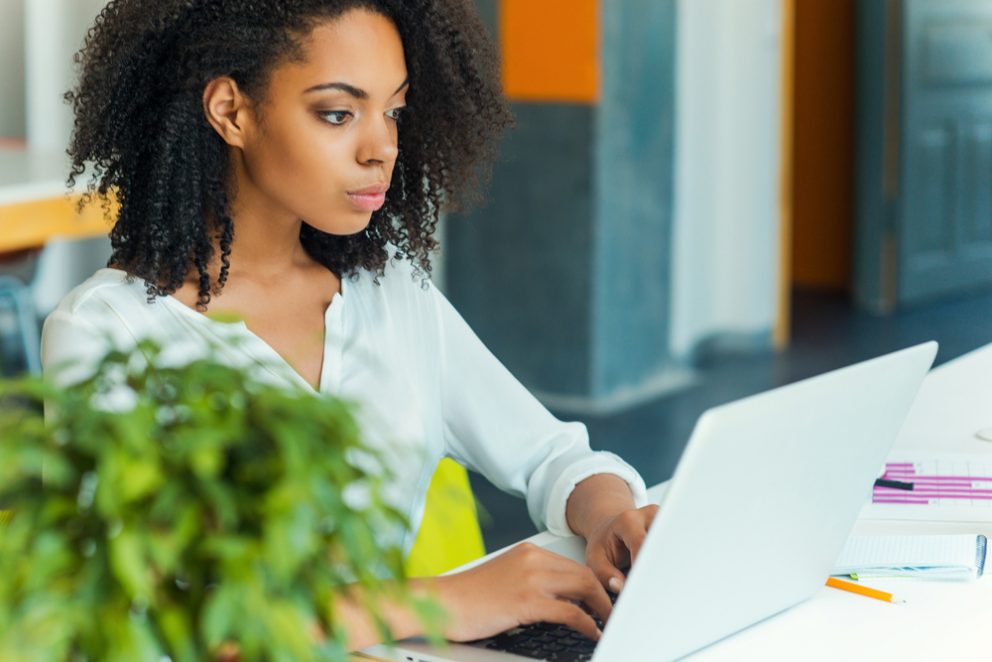 Woman thinking at a computer.