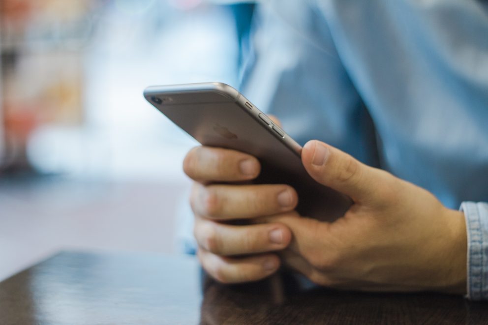 Man using an employee management app on his phone.