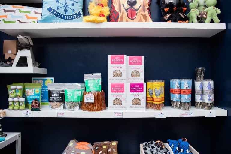 A variety of inventory displayed on shelves at a pet store.