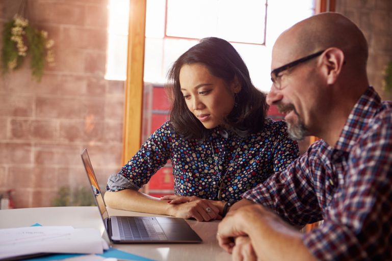 Small business shop owners choosing a social media channel.