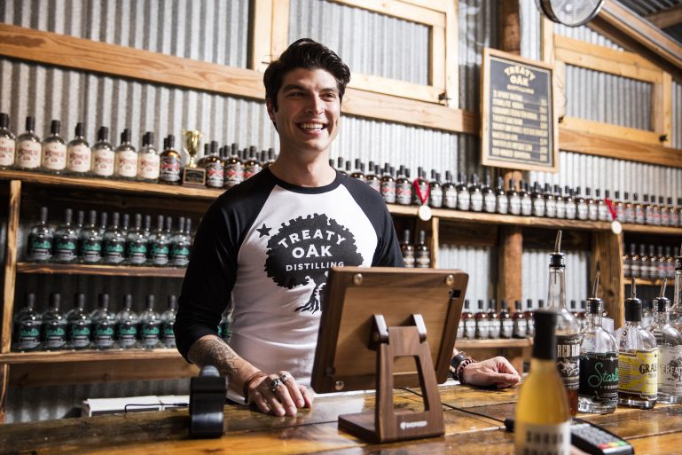 bar owner smiling with his ShopKeep system