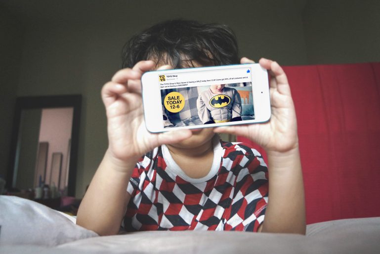 child playing on phone with toy discount on screen