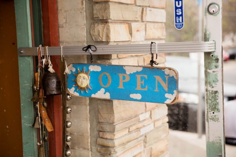 a shop's blue open sign