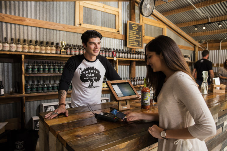 customer using contactless payment at a bar