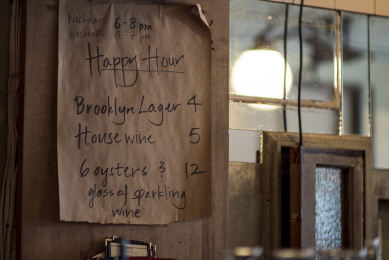 happy hour specials posted on wall - opening a bar