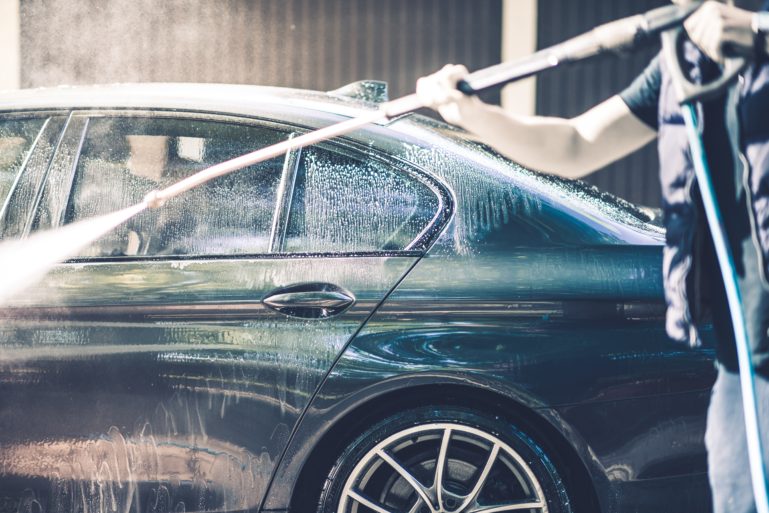 man washing his car - business ideas for small towns