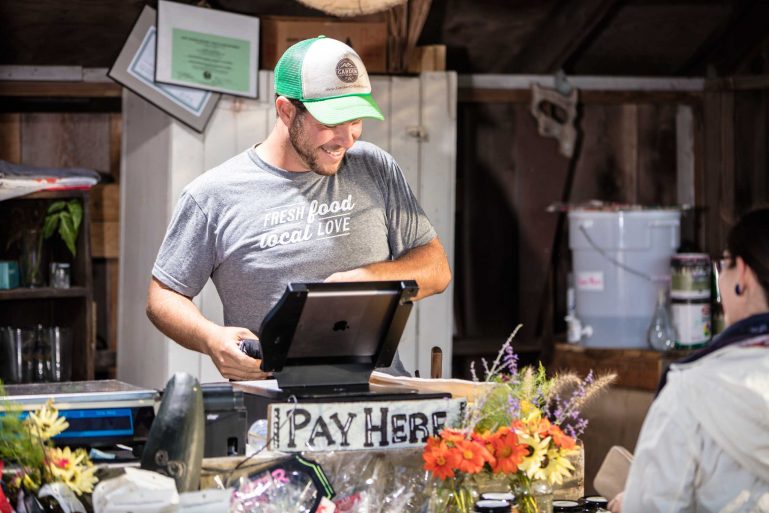 Smiling Merchant at The Stand