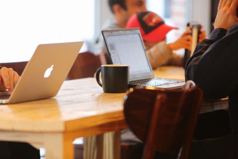 man in a coffee shop working on a laptop - what is a business plan