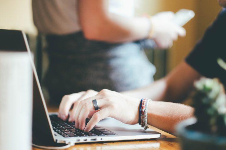 person with wedding ring typing on the computer - what is a business plan