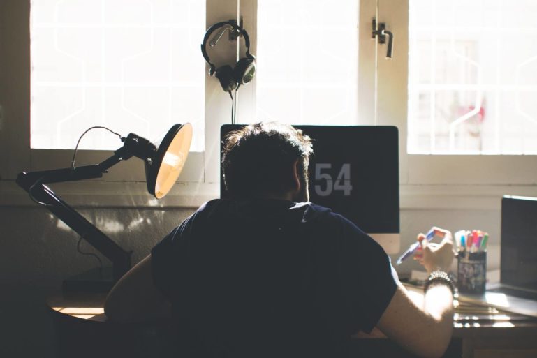 man sitting in front of computer - collecting sales tax online