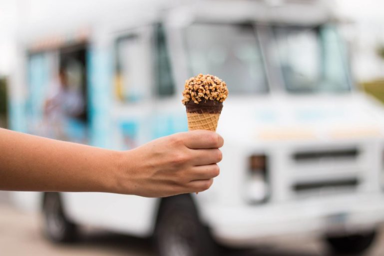 hand holding ice cream - starting an ice cream truck business