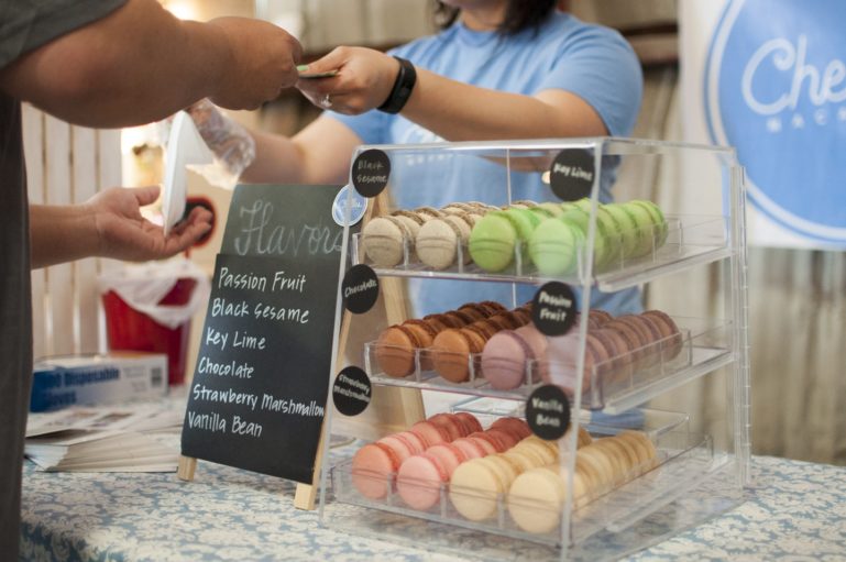 person selling macaroons at farm stand - promotion ideas for retail sales