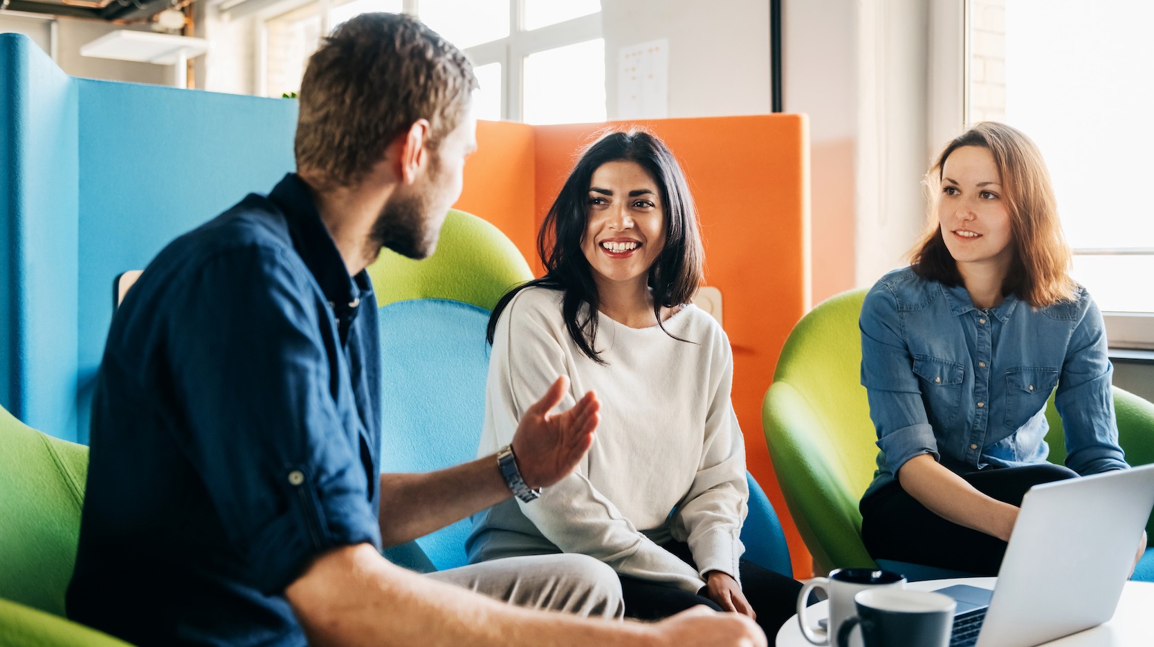 Coworkers talking at office