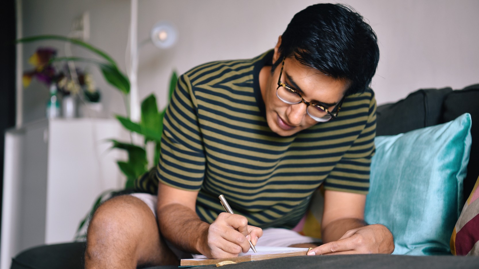 Student writing on paper