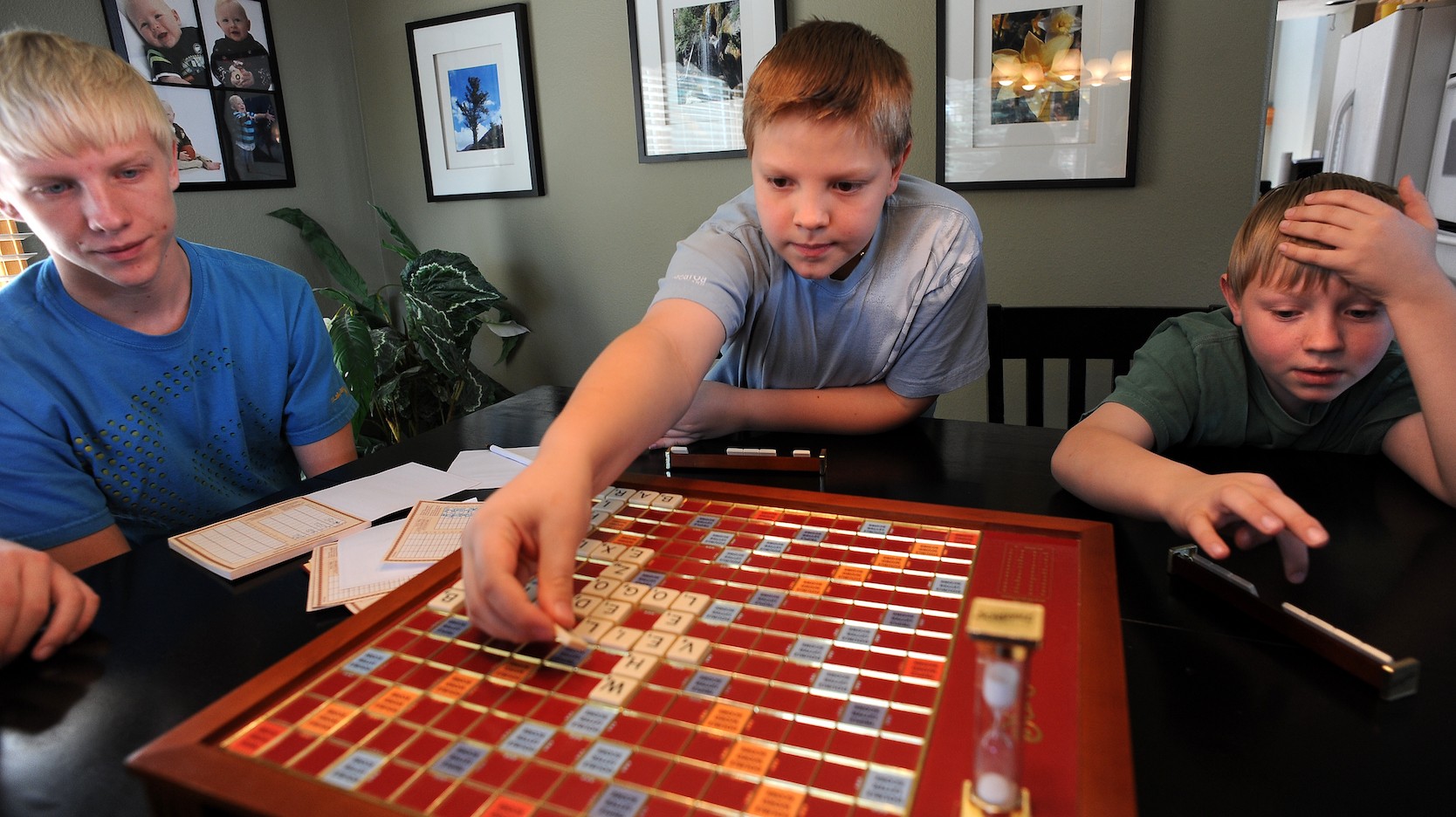 boys playing scrabble at table