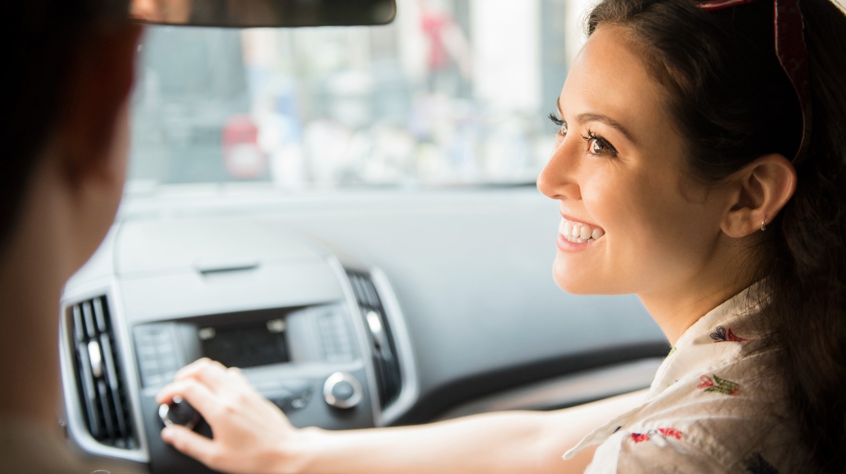 woman changing car radio