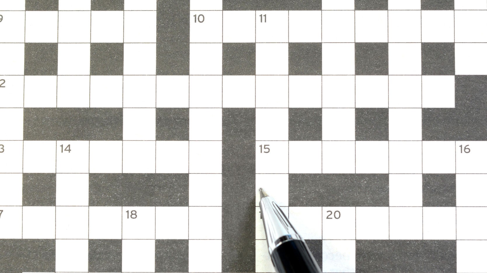 Empty crossword puzzle with pen