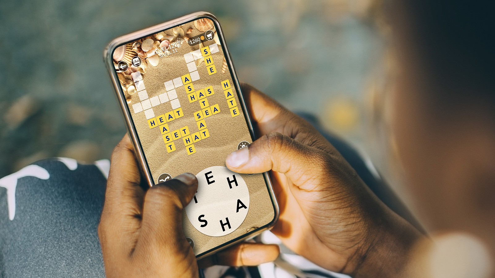 woman plays Wordscapes on her phone